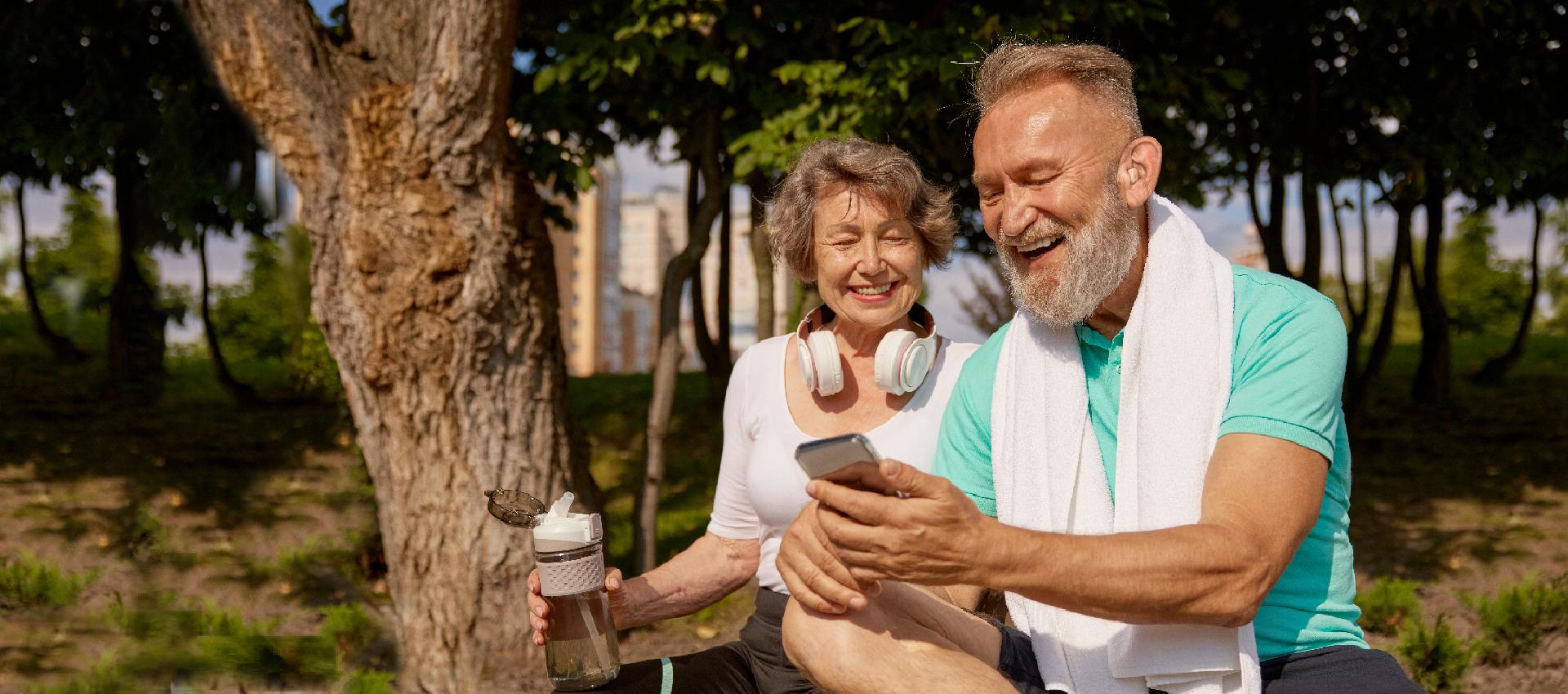 Senior couple wearing hearing aid enjoying outdoors